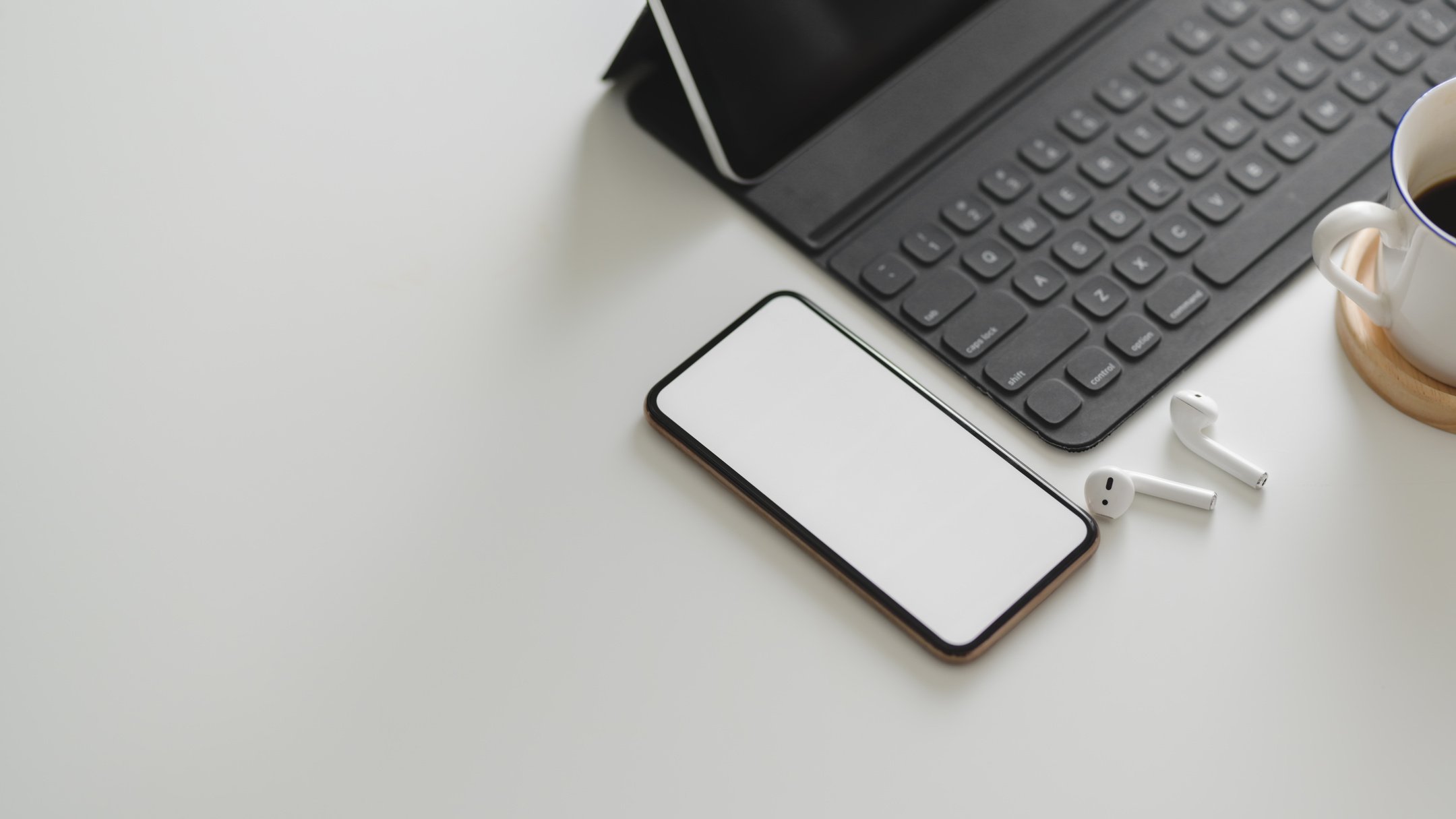 White Smartphone Near Black Keyboard